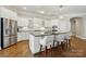 Bright kitchen features white cabinetry, stainless steel appliances, and a large center island with bar seating at 1038 Gardenia St, Fort Mill, SC 29708