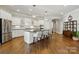 Bright kitchen features white cabinetry, stainless steel appliances, and a large center island with bar seating at 1038 Gardenia St, Fort Mill, SC 29708