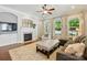 Cozy living room with a fireplace, large windows, and comfortable seating at 1038 Gardenia St, Fort Mill, SC 29708