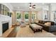 Bright living room featuring a fireplace, large windows, and hardwood floors at 1038 Gardenia St, Fort Mill, SC 29708