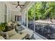 Relaxing screened-in porch with comfortable seating offering a tranquil view of the lush green landscape at 1038 Gardenia St, Fort Mill, SC 29708
