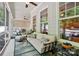 Inviting screened-in porch with stylish seating and decor, offering a peaceful retreat with ample natural light at 1038 Gardenia St, Fort Mill, SC 29708