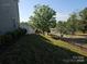 View of the home's backyard, featuring a fence and an open grassy area at 106 Calderdale Ln, Charlotte, NC 28262