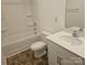 White toilet, bathtub and sink with dark vinyl flooring at 106 Calderdale Ln, Charlotte, NC 28262