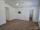 This bedroom is spacious, with carpet flooring and access to the ensuite and walk-in closet at 106 Calderdale Ln, Charlotte, NC 28262