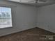 Bright bedroom with neutral walls, plush carpet, and a large window allowing for plenty of natural light at 106 Calderdale Ln, Charlotte, NC 28262