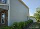 This two-story house has gray siding and a brick pillar, as well as a fence and greenery at 106 Calderdale Ln, Charlotte, NC 28262