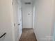 Hallway that leads into a room with doors and carpet flooring at 106 Calderdale Ln, Charlotte, NC 28262