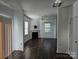 Bright and airy living room with hardwood floors, a fireplace, and plentiful natural light from multiple windows at 106 Calderdale Ln, Charlotte, NC 28262
