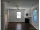 Spacious living room featuring a cozy fireplace, ceiling fan, and large windows for ample natural light at 106 Calderdale Ln, Charlotte, NC 28262