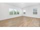 Bright, empty bedroom featuring wood-look floors and large windows at 111 Stonewater Dr # 25, Red Cross, NC 28129