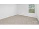 Bright bedroom featuring neutral carpet, white walls, and a window with blinds at 111 Stonewater Dr # 25, Red Cross, NC 28129
