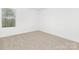A bright bedroom featuring neutral carpet, white walls, and a window with blinds at 111 Stonewater Dr # 25, Red Cross, NC 28129