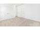 Bright bedroom featuring neutral carpet, white walls, and double door closet at 111 Stonewater Dr # 25, Red Cross, NC 28129