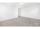 A bedroom featuring neutral carpet and white walls; illuminated by a ceiling light at 111 Stonewater Dr # 25, Red Cross, NC 28129