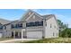 Charming two-story home featuring gray siding, black shutters, and a two-car garage at 111 Stonewater Dr # 25, Red Cross, NC 28129