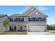 Charming two-story home featuring gray siding, black shutters, and a two-car garage at 111 Stonewater Dr # 25, Red Cross, NC 28129
