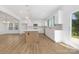 Bright, open-concept kitchen featuring white cabinets, stainless steel appliances, and a large island at 111 Stonewater Dr # 25, Red Cross, NC 28129