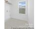 Bright laundry room featuring tile floors, white walls, and a window offering abundant natural light at 111 Stonewater Dr # 25, Red Cross, NC 28129