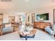 Open-concept living area with comfortable seating, hardwood floors, and lots of natural light at 12136 Devon Square Ct, Charlotte, NC 28262