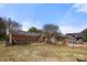 View of a brick home's backyard, featuring a gazebo and fully fenced yard at 124 Hunters Creek Dr, Mooresville, NC 28115