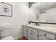 Stylish bathroom features a white vanity, granite countertop, modern fixtures, and wood flooring at 124 Hunters Creek Dr, Mooresville, NC 28115