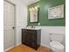 Updated bathroom features a dark vanity, decorative mirror, and white wainscoting at 124 Hunters Creek Dr, Mooresville, NC 28115
