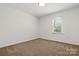 Neutral bedroom with carpet, window bringing natural light, and ample space at 124 Hunters Creek Dr, Mooresville, NC 28115