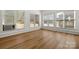Bright bonus room featuring three windows and durable laminate flooring at 124 Hunters Creek Dr, Mooresville, NC 28115