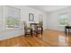 Charming dining area with hardwood floors, natural light from three windows, and a small table for two at 124 Hunters Creek Dr, Mooresville, NC 28115