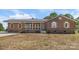 Charming brick ranch featuring a metal roof, wooden window shutters, and an inviting covered porch at 124 Hunters Creek Dr, Mooresville, NC 28115