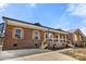 Charming brick home with a covered porch, wooden shutters, and a driveway at 124 Hunters Creek Dr, Mooresville, NC 28115