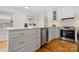 Well-lit kitchen with quartz counters, stainless steel appliances, and custom cabinets at 124 Hunters Creek Dr, Mooresville, NC 28115