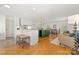 Open concept living space with hardwood floors, green island, and white cabinets at 124 Hunters Creek Dr, Mooresville, NC 28115