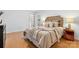 Nicely decorated main bedroom with a wooden headboard, a side table, and hardwood floors at 124 Hunters Creek Dr, Mooresville, NC 28115