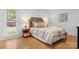 Well-lit main bedroom featuring a wooden headboard and stylish decor at 124 Hunters Creek Dr, Mooresville, NC 28115