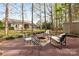 Charming backyard featuring a stone fire pit, mature trees, and outdoor seating at 12628 Waterfall Pl, Charlotte, NC 28278