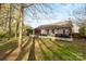 Backyard featuring a cozy patio, hot tub, fenced-in backyard, and lush greenery at 12628 Waterfall Pl, Charlotte, NC 28278