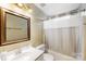 Bathroom featuring tile floors, a mirror with frame, and bathtub with shower at 12628 Waterfall Pl, Charlotte, NC 28278