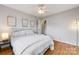 Spacious bedroom features light gray walls, hardwood floors, and ceiling fan with lighting at 12628 Waterfall Pl, Charlotte, NC 28278