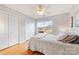 Bedroom with hardwood floors, ceiling fan, natural light, and double door closet at 12628 Waterfall Pl, Charlotte, NC 28278