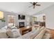 Bright living room with hardwood floors, fireplace, large windows, and an open floor plan at 12628 Waterfall Pl, Charlotte, NC 28278