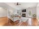 Cozy living room featuring a fireplace, hardwood floors, and plenty of natural light at 12628 Waterfall Pl, Charlotte, NC 28278