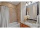 Bathroom featuring tile walls, granite countertop, and decorative framed mirror at 1305 Anniston Pl, Wesley Chapel, NC 28079