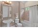 A bathroom with a pedestal sink, standard toilet and shower-tub combination at 1305 Anniston Pl, Wesley Chapel, NC 28079