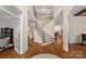 Spacious entryway with hardwood floors, a grand staircase, and elegant architectural details at 1305 Anniston Pl, Wesley Chapel, NC 28079