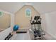 Well-equipped exercise room with elliptical machine, weights, and ample space for workout routines at 1305 Anniston Pl, Wesley Chapel, NC 28079