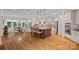 Open kitchen with granite countertops, a large island, stainless steel appliances, and modern lighting at 1305 Anniston Pl, Wesley Chapel, NC 28079