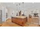 Spacious kitchen with granite island, wood floors, and stainless steel appliances at 1305 Anniston Pl, Wesley Chapel, NC 28079