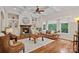 A living room with coffered ceilings, fireplace, hardwood floors and large windows at 1305 Anniston Pl, Wesley Chapel, NC 28079